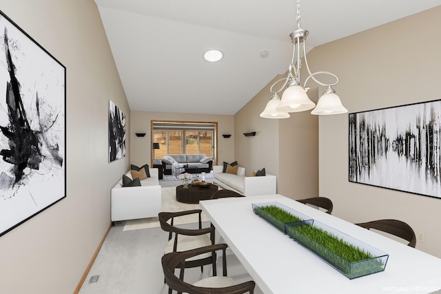 dining space with lofted ceiling and baseboards