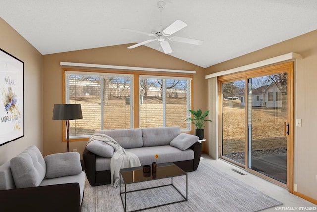 living area with vaulted ceiling, ceiling fan, light carpet, and visible vents