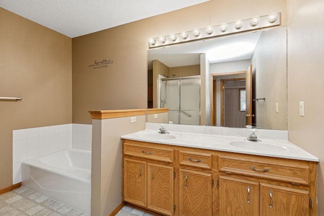 full bath with a sink, a shower stall, a bath, and double vanity