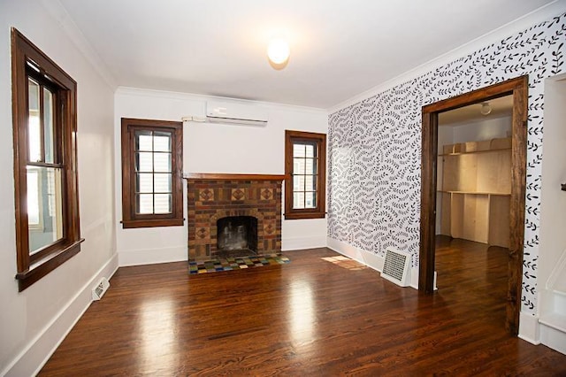 unfurnished living room featuring a wall mounted air conditioner, wood finished floors, visible vents, and crown molding