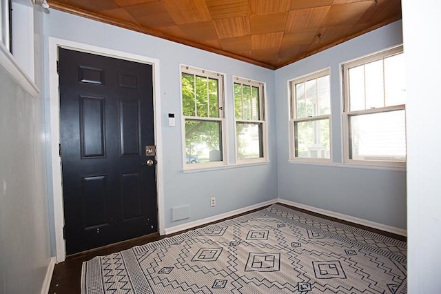 entrance foyer with wood ceiling, baseboards, and crown molding