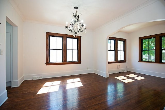 unfurnished room with ornamental molding, visible vents, dark wood finished floors, and baseboards