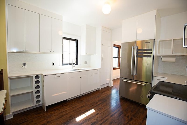 kitchen featuring dark wood-style floors, high end fridge, light countertops, and a sink