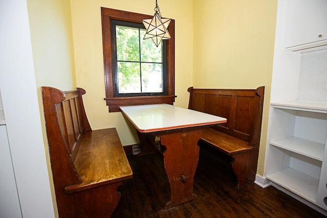 dining area featuring dark wood-style floors and a chandelier