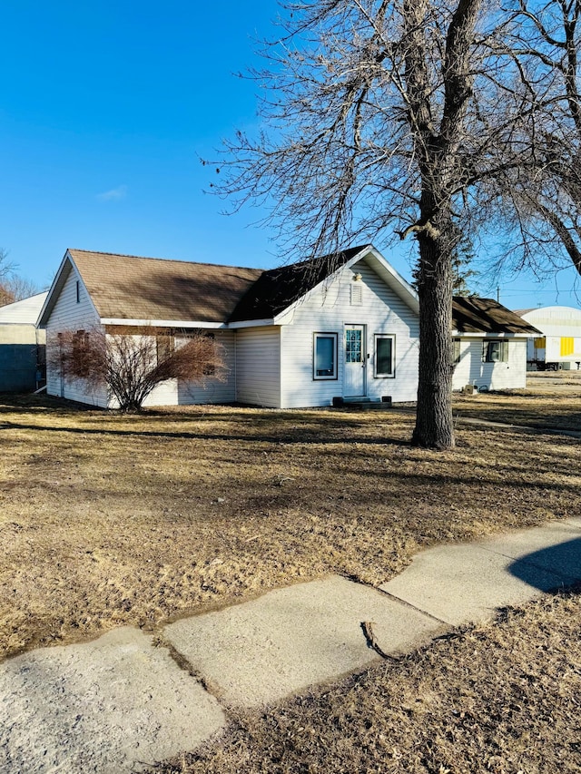 view of side of property with a yard