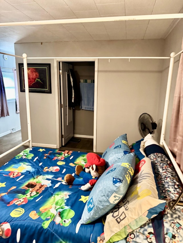 bedroom with baseboards and a closet