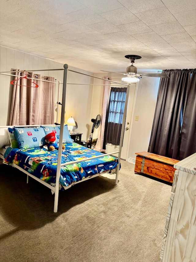 bedroom featuring carpet, ceiling fan, and a textured ceiling