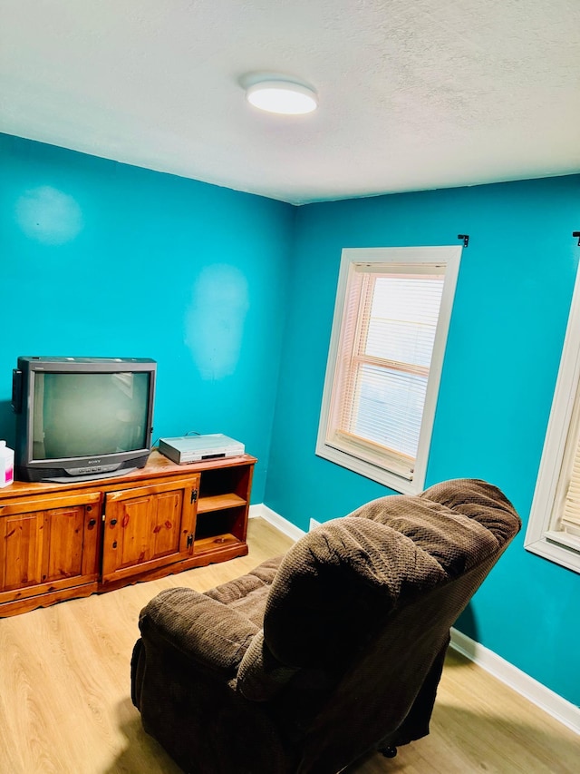 interior space featuring wood finished floors and baseboards