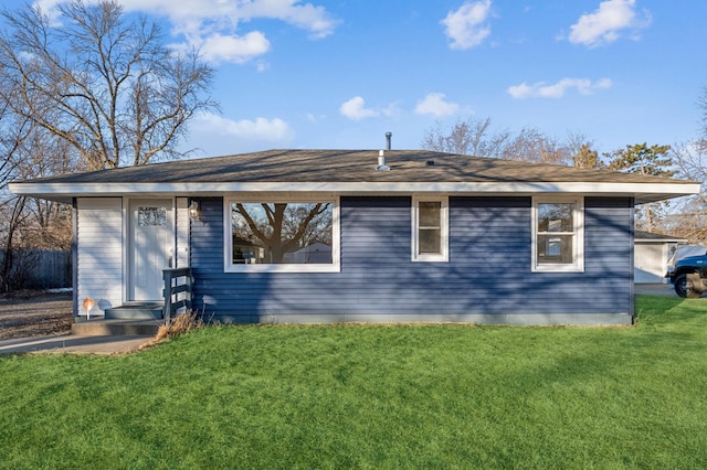 back of house featuring a yard