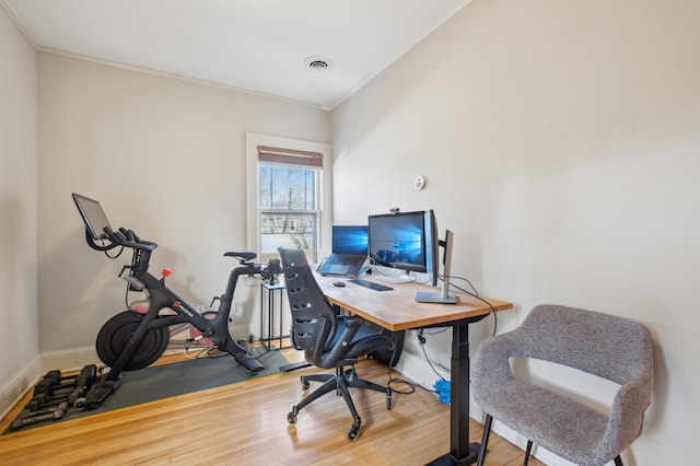 office area featuring ornamental molding, wood finished floors, and baseboards
