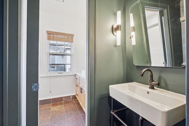 bathroom featuring a sink and baseboards