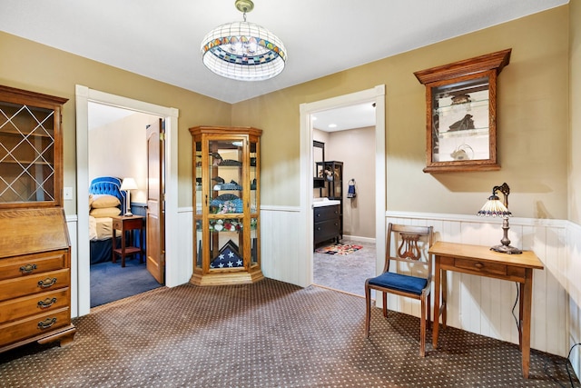 hallway with wainscoting and carpet