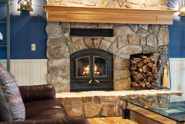 interior space with a fireplace and wainscoting