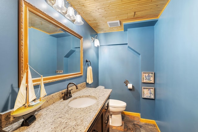 half bath featuring toilet, visible vents, stone finish flooring, wood ceiling, and baseboards