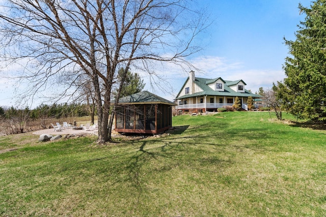 view of yard featuring a sunroom and a patio