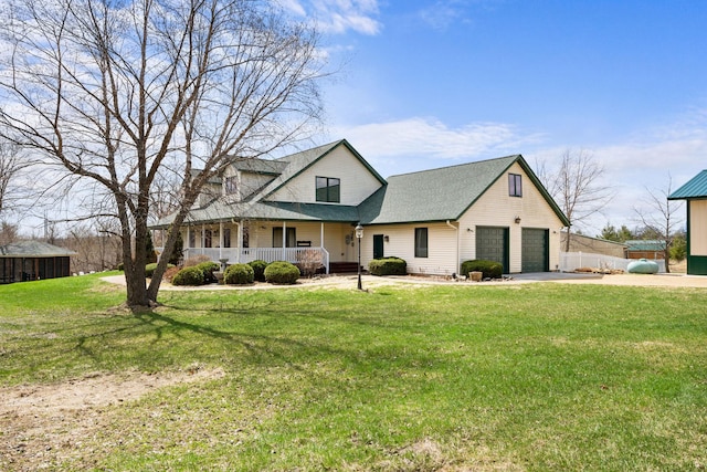 view of front of home featuring concrete driveway, a front yard, roof with shingles, and covered porch