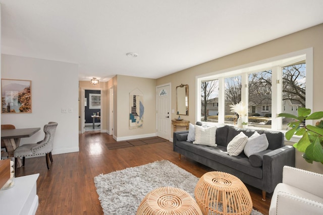 living area with baseboards and wood finished floors