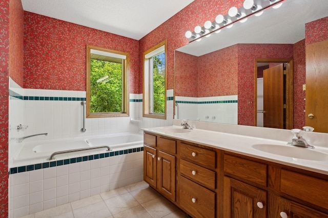 bathroom with double vanity, wallpapered walls, a sink, tile patterned flooring, and a bath