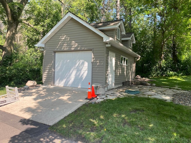 detached garage with concrete driveway