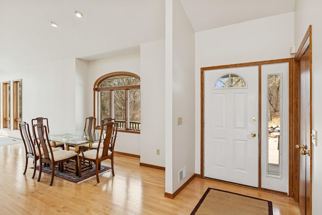 foyer entrance with baseboards, light wood finished floors, visible vents, and recessed lighting