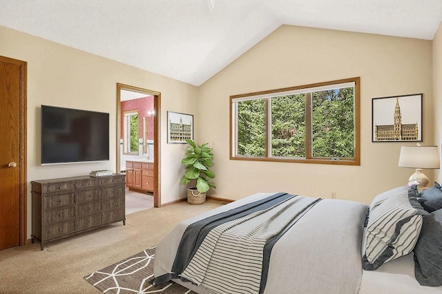 bedroom featuring lofted ceiling, connected bathroom, and light colored carpet