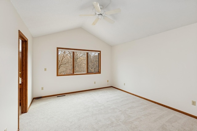 unfurnished room with vaulted ceiling, light carpet, ceiling fan, and visible vents
