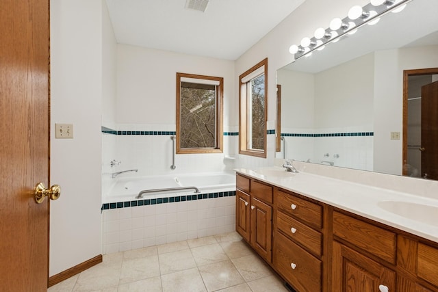 bathroom featuring a garden tub, a sink, double vanity, tile patterned flooring, and visible vents