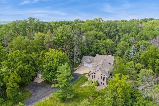 drone / aerial view with a wooded view
