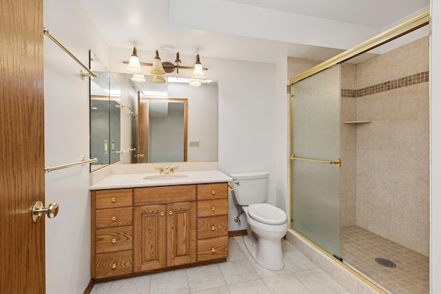 full bathroom featuring vanity, tile patterned flooring, a shower stall, and toilet