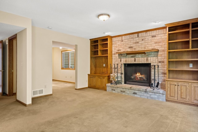 unfurnished living room with baseboards, a fireplace, visible vents, and carpet
