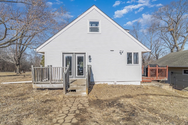 back of house with a wooden deck