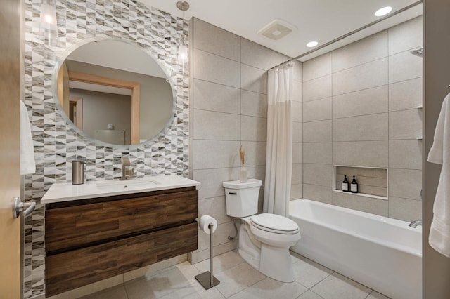 bathroom with toilet, shower / bath combo with shower curtain, tile walls, and tile patterned floors