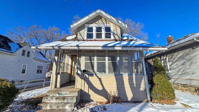 view of front of home featuring a sunroom