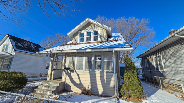 bungalow-style home with a sunroom