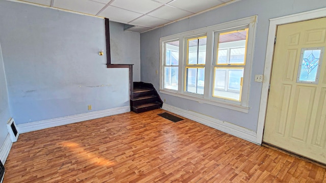 entryway featuring visible vents, baseboards, and wood finished floors