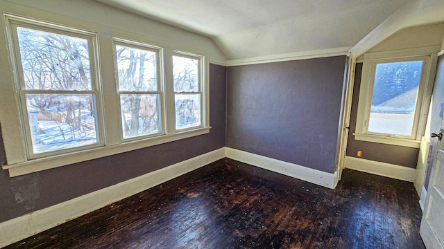 unfurnished room with baseboards, lofted ceiling, and dark wood-style flooring