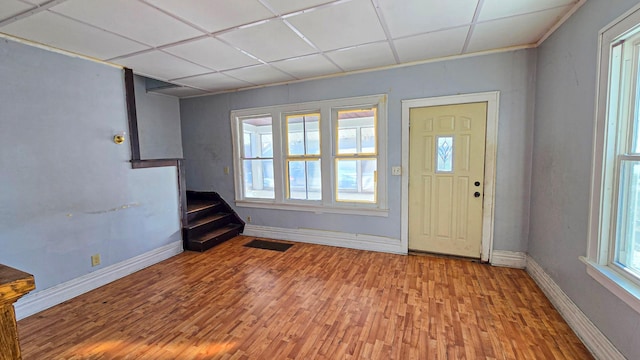 entrance foyer with baseboards, stairs, wood finished floors, and visible vents
