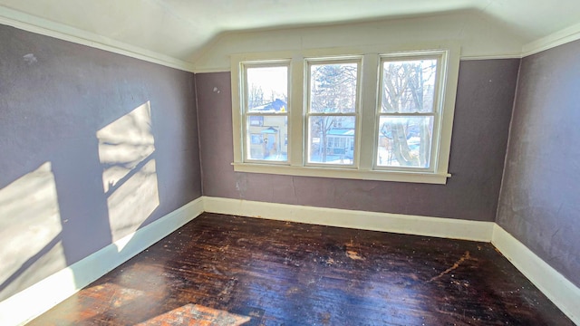 unfurnished room featuring wood-type flooring, baseboards, and lofted ceiling
