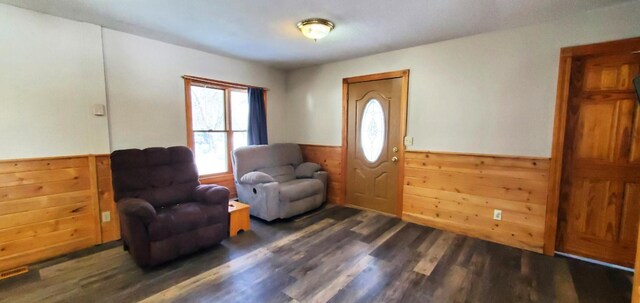 entryway featuring wainscoting, wooden walls, and wood finished floors