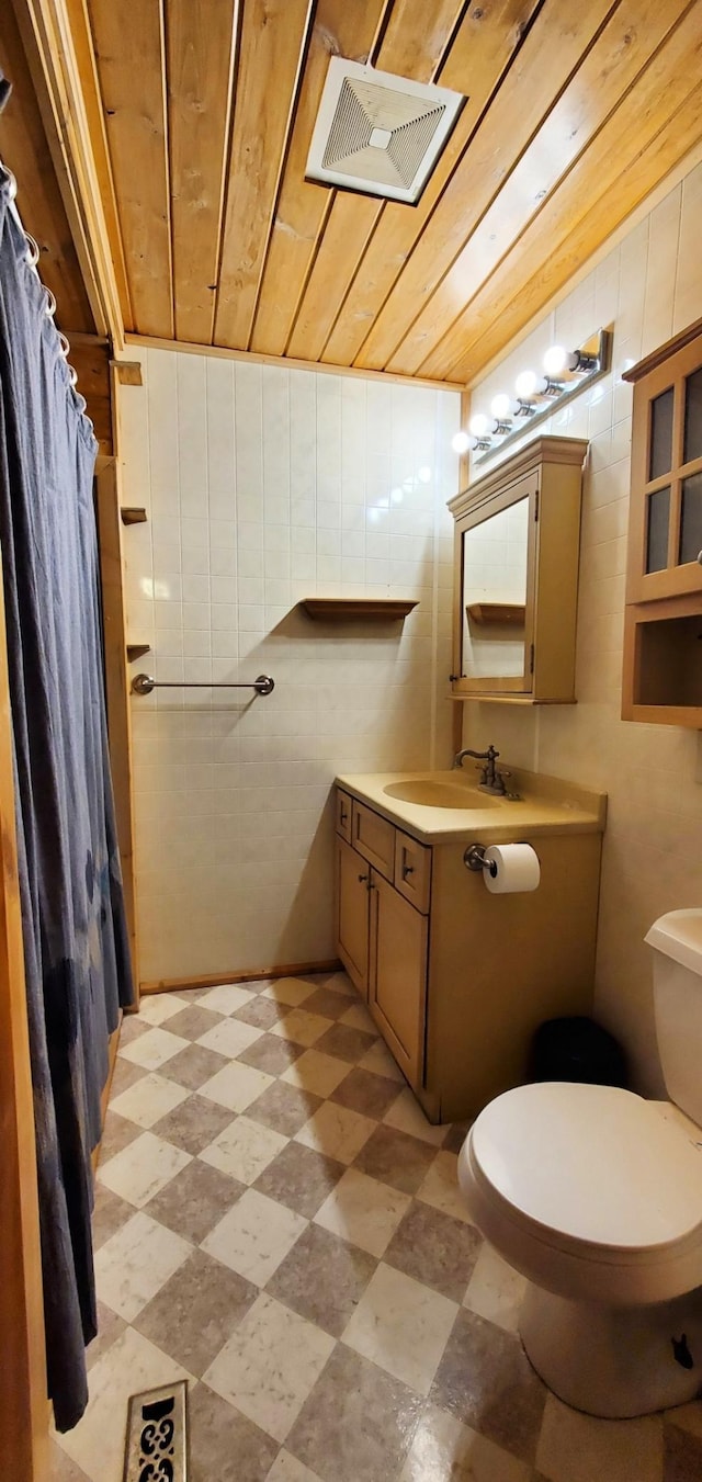 bathroom with visible vents, toilet, wooden ceiling, tile patterned floors, and vanity