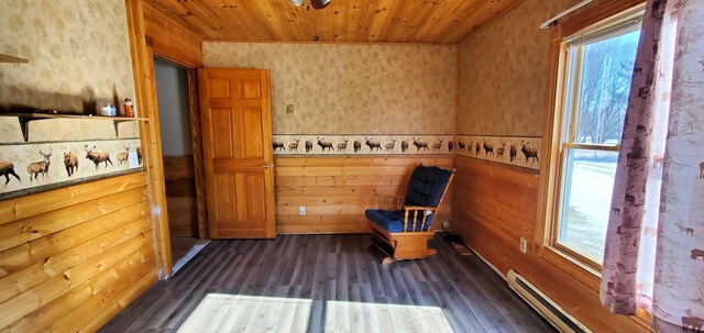 interior space with wooden ceiling, baseboard heating, a wealth of natural light, and dark wood-type flooring