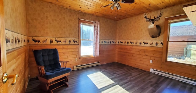 unfurnished room featuring dark wood-style floors, wood ceiling, wooden walls, and a baseboard heating unit