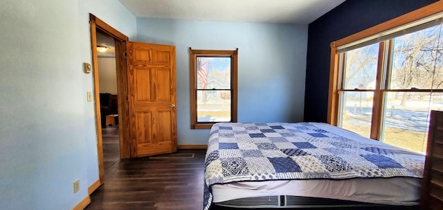 bedroom with baseboards and dark wood-type flooring