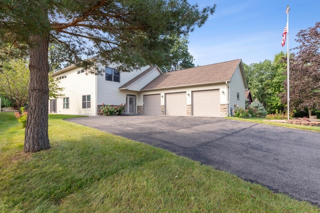 view of front of home with aphalt driveway, stone siding, a front lawn, and an attached garage