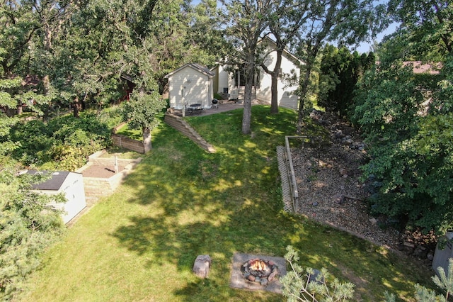 view of yard with a garden and a fire pit