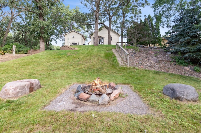 view of yard featuring an outdoor fire pit