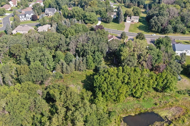 aerial view featuring a wooded view and a residential view