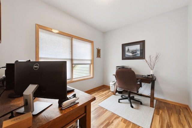 office with light wood-type flooring and baseboards