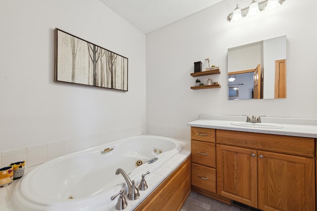 bathroom with vanity and a whirlpool tub