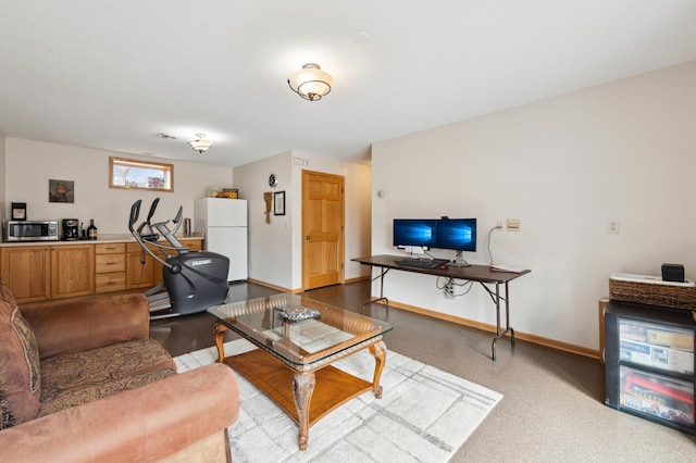 living area featuring baseboards